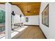 Covered porch featuring a wooden ceiling, ceiling fan and dark trim, with view to spacious backyard at 915 John Ward Rd, Marietta, GA 30064