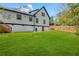 Expansive green lawn in the backyard showcases the home's architectural details and a privacy fence at 915 John Ward Rd, Marietta, GA 30064