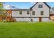 Manicured lawn highlights a two-story home featuring a wooden deck and contrasting white and black trim at 915 John Ward Rd, Marietta, GA 30064