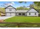 Charming two-story home with black trim, white siding, two-car garage and expansive front lawn at 915 John Ward Rd, Marietta, GA 30064