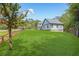 Sprawling green lawn surrounding a stylish, two-story home, bordered by a rustic wooden fence at 915 John Ward Rd, Marietta, GA 30064