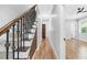 Hallway with hardwood floors and a wrought iron banister staircase, leading to the bedrooms at 915 John Ward Rd, Marietta, GA 30064