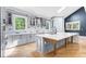 Modern kitchen with gray cabinets, white countertops, stainless steel appliances, and a large island at 915 John Ward Rd, Marietta, GA 30064