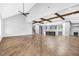 Open concept living room featuring hardwood floors, high ceilings, exposed wood beams, and staircase at 915 John Ward Rd, Marietta, GA 30064