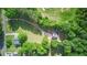 Aerial view of property showcasing expansive lot with winding driveway and lush tree coverage at 655 Poplar Rd, Dallas, GA 30157