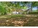 A spacious backyard with RV parking, adjacent to the home's exterior and surrounded by lush trees at 655 Poplar Rd, Dallas, GA 30157