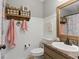 Cozy bathroom featuring white walls, a granite sink, and decorative nautical elements for a charming design at 655 Poplar Rd, Dallas, GA 30157