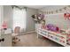 Bedroom with bright, cheery colors, comfortable bed and a desk with office chair at 655 Poplar Rd, Dallas, GA 30157