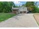 Well-maintained home with a long driveway and a large lawn in a wooded setting at 655 Poplar Rd, Dallas, GA 30157