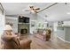Inviting living room featuring a stone fireplace, vaulted ceiling, and modern decor at 655 Poplar Rd, Dallas, GA 30157