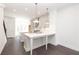 Bright, open kitchen featuring an island, stainless steel appliances, and modern pendant lighting at 109 Iveybrooke Ln # 59, Alpharetta, GA 30009