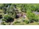 An aerial view reveals the house with large trees, the pool, an outbuilding, and a circular driveway at 2405 Old Salem Se Rd, Conyers, GA 30013