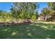 Lush backyard with well-maintained lawn, mature trees, and a small shed, offering a serene outdoor space at 2405 Old Salem Se Rd, Conyers, GA 30013
