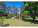 Large backyard with shade trees, green lawn, and a shed, perfect for enjoying outdoor living at 2405 Old Salem Se Rd, Conyers, GA 30013