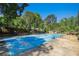 This backyard showcases a blue covered pool surrounded by a concrete patio and lush greenery at 2405 Old Salem Se Rd, Conyers, GA 30013