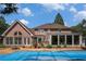 A spacious backyard with a covered pool and brick home exterior offers ample space for relaxation and entertainment at 2405 Old Salem Se Rd, Conyers, GA 30013