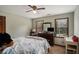 Bedroom with two windows, a ceiling fan, carpet, and an armoire used as a media center at 2405 Old Salem Se Rd, Conyers, GA 30013