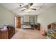 Neutral carpeted bedroom featuring a ceiling fan, natural light and plenty of space for storage and sleep at 2405 Old Salem Se Rd, Conyers, GA 30013