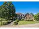 Charming two-story brick home featuring a well-manicured lawn and mature landscaping at 2405 Old Salem Se Rd, Conyers, GA 30013