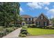 Classic brick home with manicured landscaping, a well-maintained lawn, and a curved walkway to the front door at 2405 Old Salem Se Rd, Conyers, GA 30013