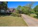Attractive suburban home with circular driveway, lush green lawn, and mature landscaping at 2405 Old Salem Se Rd, Conyers, GA 30013