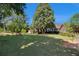 Expansive front yard showcasing mature trees and lush lawn surrounding a stately brick home at 2405 Old Salem Se Rd, Conyers, GA 30013