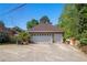 The property includes a detached two-car garage with a concrete driveway and some surrounding vegetation at 2405 Old Salem Se Rd, Conyers, GA 30013