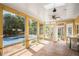 Sunroom with yellow walls, tile floor, and many windows that look out to a pool at 2405 Old Salem Se Rd, Conyers, GA 30013