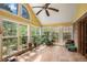 Sunroom with yellow walls, tile floor, and many windows that look out to a garden at 2405 Old Salem Se Rd, Conyers, GA 30013