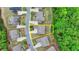 Aerial view of home with yellow property lines in a lush green suburban neighborhood at 4395 Wildbrooke Pkwy, Cumming, GA 30041
