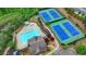 Aerial view showcasing the pool, tennis courts, clubhouse, and parking of this beautiful community at 4395 Wildbrooke Pkwy, Cumming, GA 30041
