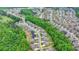 Wide aerial perspective of a home nestled in a community surrounded by mature trees at 4395 Wildbrooke Pkwy, Cumming, GA 30041