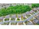 Overhead shot of a home with a manicured lawn in a verdant neighborhood setting at 4395 Wildbrooke Pkwy, Cumming, GA 30041