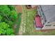 Aerial view of a well-maintained backyard featuring a wooden deck and lush green lawn at 4395 Wildbrooke Pkwy, Cumming, GA 30041
