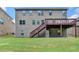 Large backyard with a lush lawn provides plenty of space for recreation, complemented by a multi-level deck and stairs at 4395 Wildbrooke Pkwy, Cumming, GA 30041