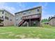 Expansive backyard features a well-maintained lawn, and a deck with stairs, ideal for outdoor activities at 4395 Wildbrooke Pkwy, Cumming, GA 30041