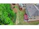 Aerial shot of back of a two-story home with a deck and green, manicured lawn at 4395 Wildbrooke Pkwy, Cumming, GA 30041