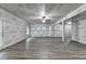 Unfinished basement with laminate floors, ceiling fan, and protective covering on walls at 4395 Wildbrooke Pkwy, Cumming, GA 30041