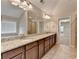 Bright bathroom with a granite countertop vanity, double sinks, and plenty of mirror space at 4395 Wildbrooke Pkwy, Cumming, GA 30041