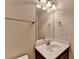 Bathroom featuring a modern vanity with granite countertop, framed mirror, and decorative lighting at 4395 Wildbrooke Pkwy, Cumming, GA 30041
