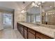 Bright bathroom featuring a soaking tub, granite countertop vanity, double sinks, and walk-in shower at 4395 Wildbrooke Pkwy, Cumming, GA 30041