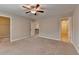 Bedroom with carpet floors featuring a ceiling fan and multiple entry doors at 4395 Wildbrooke Pkwy, Cumming, GA 30041