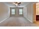 Spacious bedroom with large windows, neutral walls, and a bathroom, perfect for relaxation at 4395 Wildbrooke Pkwy, Cumming, GA 30041