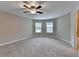 Large bedroom with neutral paint, carpeted floors, ceiling fan, and natural light at 4395 Wildbrooke Pkwy, Cumming, GA 30041