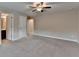 Spacious bedroom featuring neutral walls, carpet flooring, ceiling fan and a walk-in closet at 4395 Wildbrooke Pkwy, Cumming, GA 30041