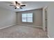 Neutral bedroom featuring carpet floors, a ceiling fan, and a window with blinds at 4395 Wildbrooke Pkwy, Cumming, GA 30041