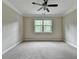 Bright bedroom with a ceiling fan and large window at 4395 Wildbrooke Pkwy, Cumming, GA 30041