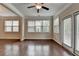 Bedroom with ceiling fan, hardwood floors, large windows, and a private balcony at 4395 Wildbrooke Pkwy, Cumming, GA 30041