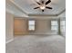 Large carpeted main bedroom featuring tray ceiling and ceiling fan at 4395 Wildbrooke Pkwy, Cumming, GA 30041