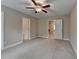 Bedroom with carpet and neutral walls, two doorways and a ceiling fan is the room's focal point at 4395 Wildbrooke Pkwy, Cumming, GA 30041